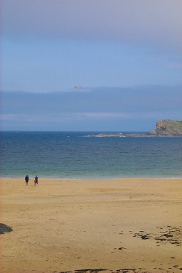 Picture of a family flying a kite on a beach