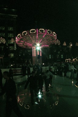 Attractions from the fairground reflect on the ice