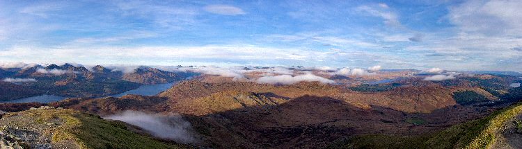 Picture of a panoramic view over hills with some low clouds