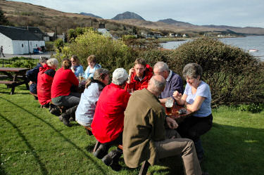 Picture of people sitting at tables in a bar garden
