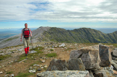 Picture of a walker (Armin) approaching with further hills in the background