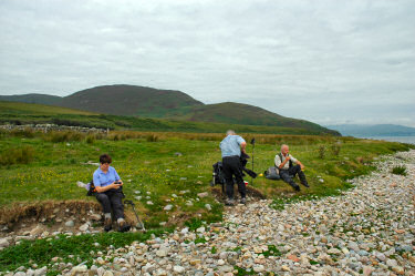 Picture of people sitting down for lunch on the shore