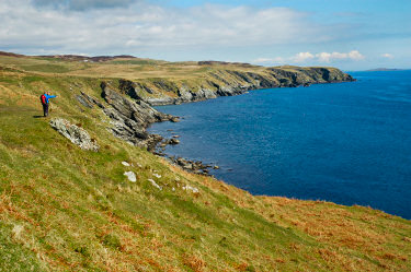 Picture of two walkers standing on the top of some cliffs