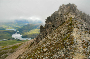 Picture of a wall of rock at the end of a path on a ridge