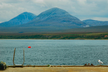 Picture of two nicely shaped mountains on the other side of a sound