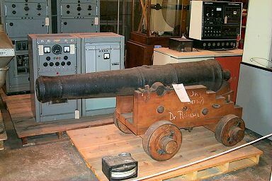 Contrasts: An old cannon in front of computers....