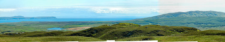 Picture of a view over a sea loch and the sea to a peninsula and another island on the other side