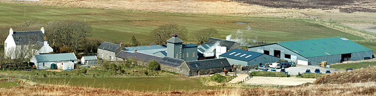 Picture of a panoramic view over a farm distillery in the middle of a farm (Kilchoman distillery at Rockside Farm, Isle of Islay)